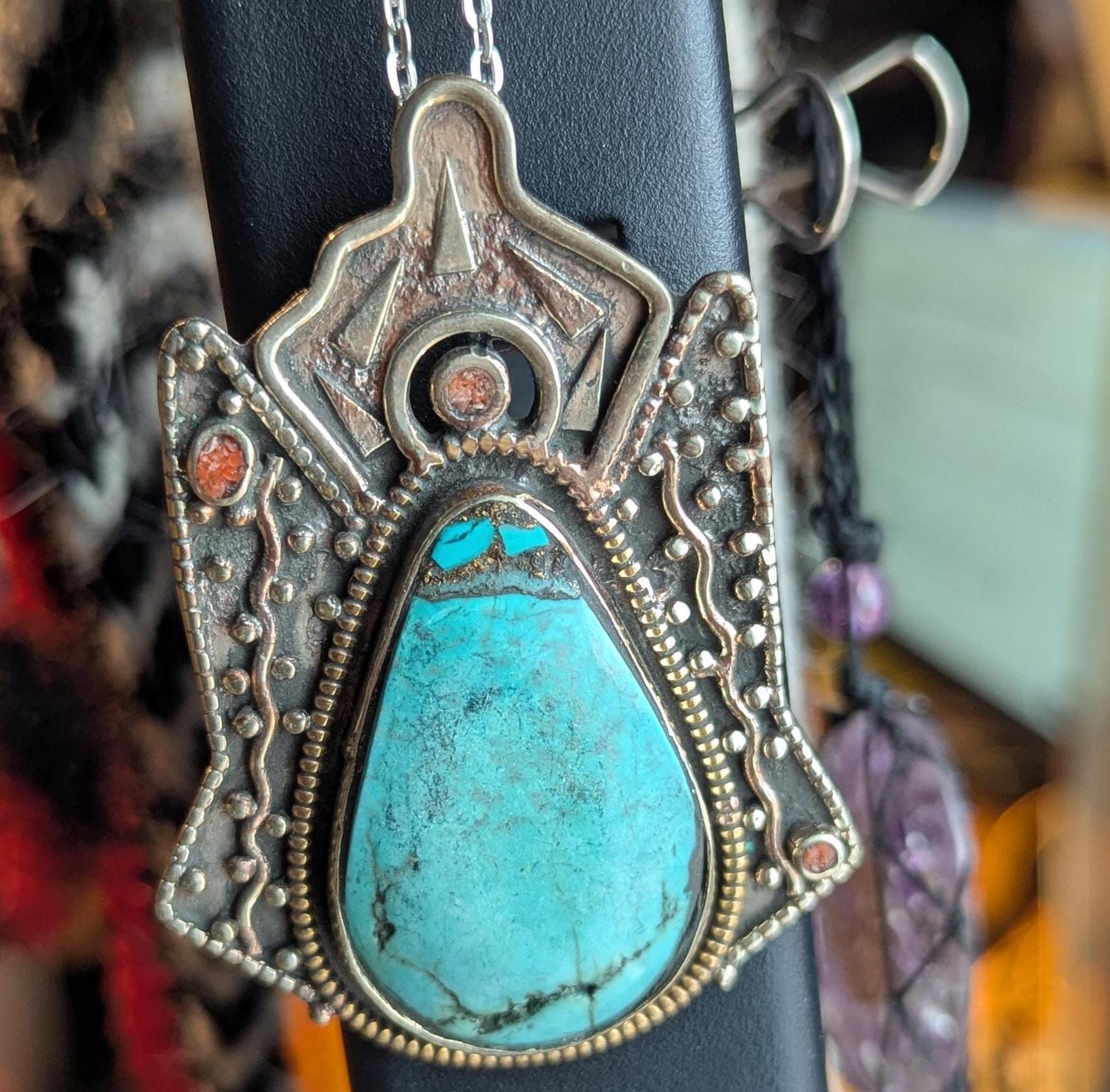 Tibetan antique ethnic pendant adorned with turquoise and coral inlays. (p6-002)